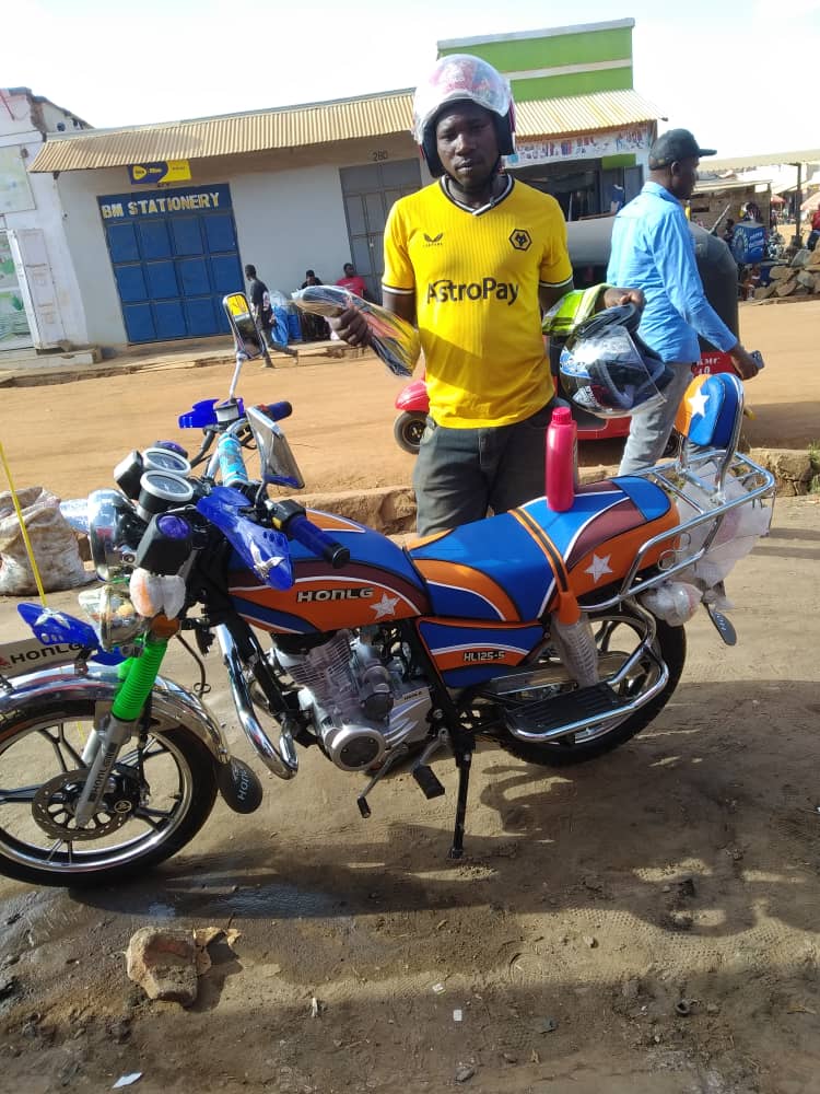 HONLG Tanzania rider with a blue business motorcycle