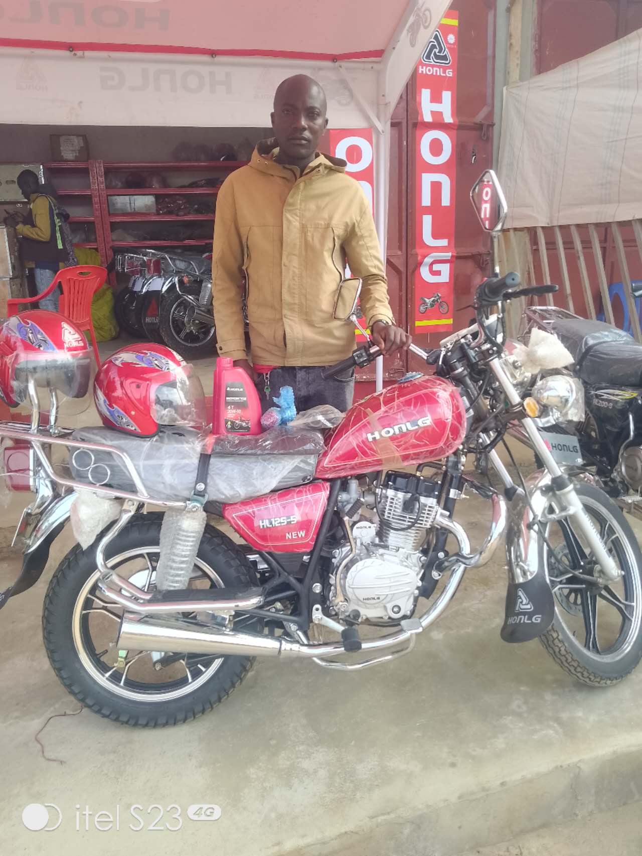 HONLG Tanzania customer with a red motorcycle at a HONLG retail location