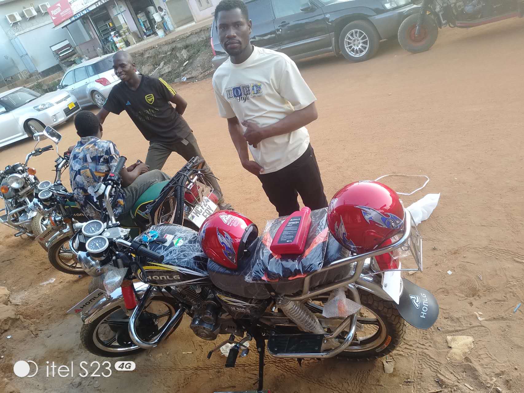 HONLG Tanzania customer receiving a red motorcycle during local delivery