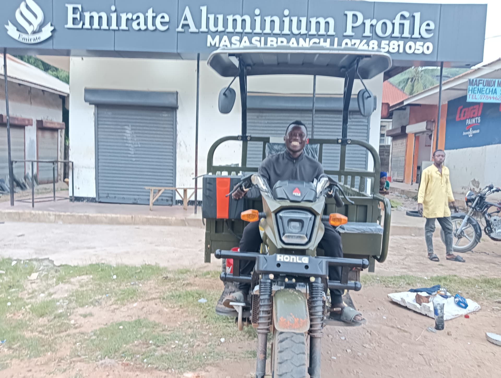 HONLG Tanzania rider seated on a cargo motorcycle