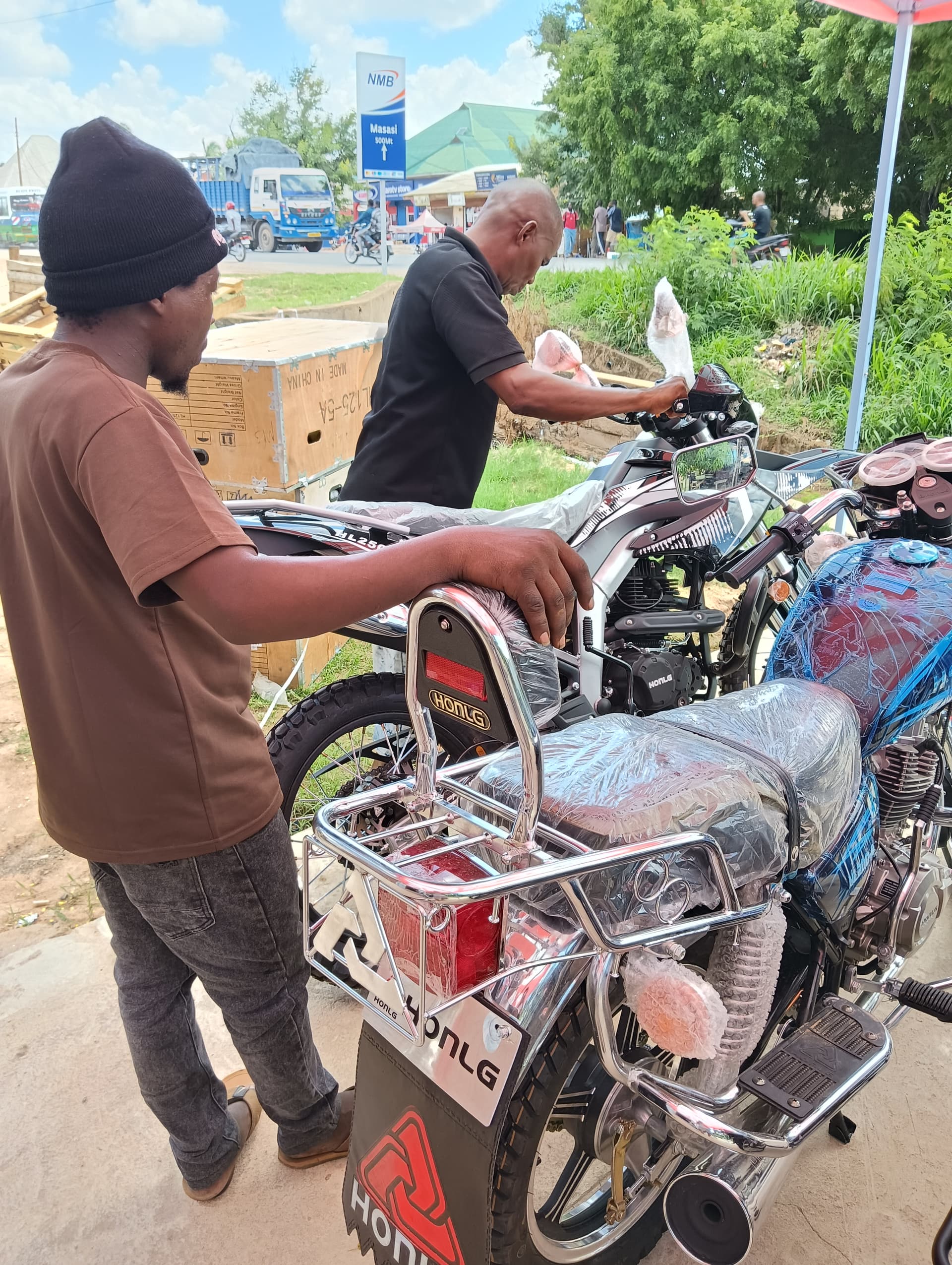 HONLG Tanzania team preparing motorcycles for customer handover