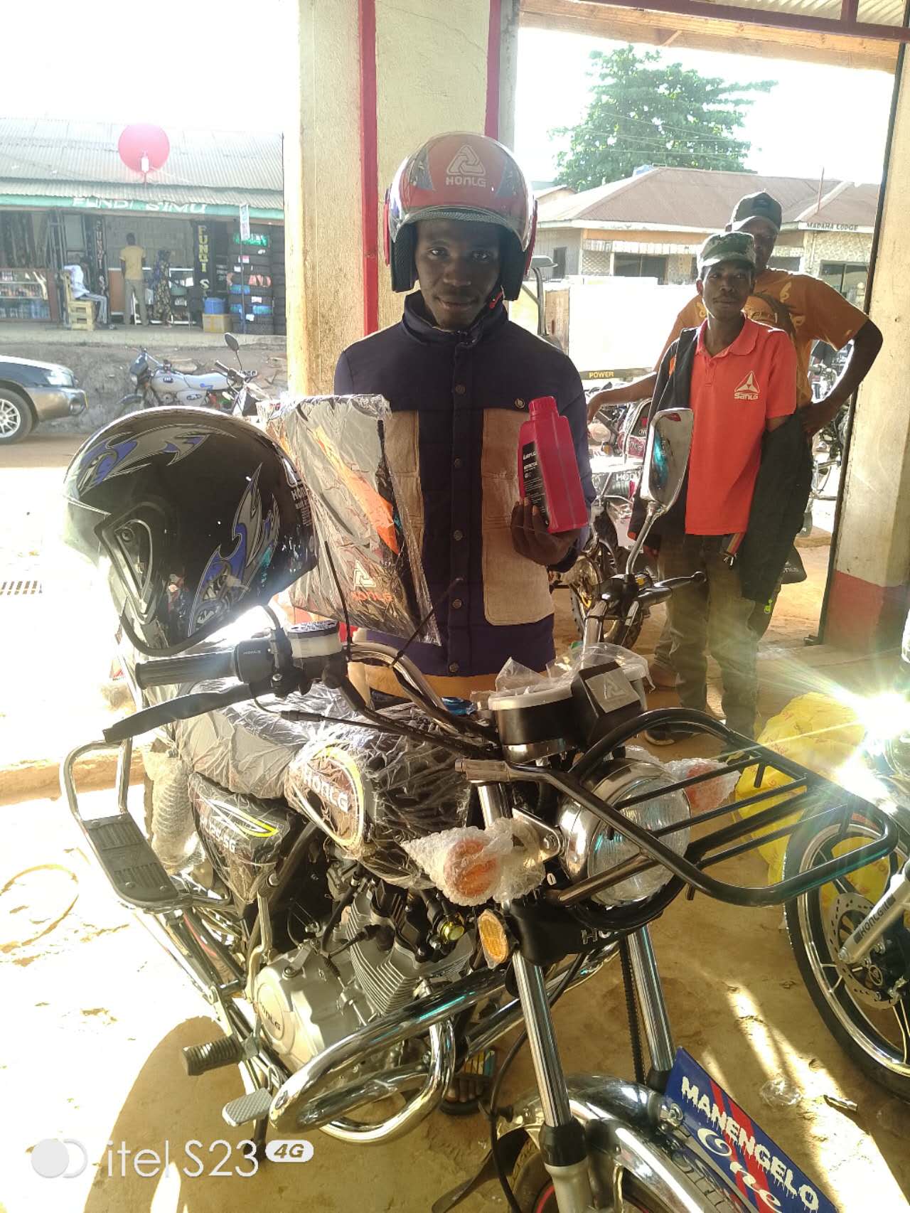 HONLG Tanzania customer receiving a newly prepared motorcycle at a local shop