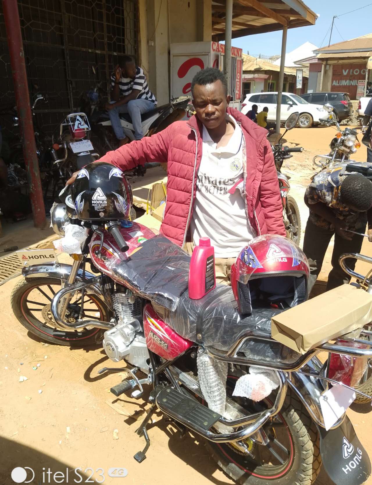 HONLG Tanzania customer collecting a motorcycle from a local shop